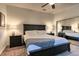 Inviting bedroom featuring a large bed, side tables, mirrored closet and neutral toned carpet at 10197 Crest View Dr, Morrison, CO 80465