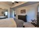 Bedroom featuring a large bed, dresser, closet with mirrored doors, and neutral-toned carpeting at 10197 Crest View Dr, Morrison, CO 80465