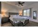 Comfortable bedroom with a queen-size bed, plush carpeting, neutral walls, ceiling fan, and bright natural light at 10197 Crest View Dr, Morrison, CO 80465