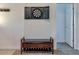 Entryway bench with padded seat, drawers, and a dartboard on the wall at 10197 Crest View Dr, Morrison, CO 80465