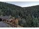 Beautiful mountain home featuring a large deck overlooking a picturesque wooded landscape at 10197 Crest View Dr, Morrison, CO 80465