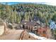 Charming home with a multi-level deck, a small shed, and a natural wooded setting at 10197 Crest View Dr, Morrison, CO 80465