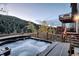 Hot tub on a wooden deck with forest views and outdoor seating at 10197 Crest View Dr, Morrison, CO 80465