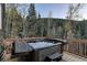 Relaxing outdoor hot tub on a wooden deck with stunning views of the surrounding trees at 10197 Crest View Dr, Morrison, CO 80465