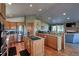 Bright kitchen with modern appliances and hardwood floors leading to the living room at 10197 Crest View Dr, Morrison, CO 80465