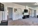 Living room with many doorways, neutral-toned carpet, and a wall mounted TV at 10197 Crest View Dr, Morrison, CO 80465