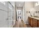 Bathroom features glass-enclosed shower, wood-look floors, and adjacent bedroom view at 2060 Peralta Loop, Castle Rock, CO 80104