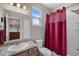 Bathroom featuring a sink with granite countertops, toilet, and a shower with a red shower curtain at 2060 Peralta Loop, Castle Rock, CO 80104