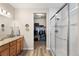 Bathroom featuring granite counters, glass shower doors, and a walk-in closet at 2060 Peralta Loop, Castle Rock, CO 80104