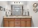 Bright bathroom featuring a double vanity with granite countertops, wooden cabinets, and a glass-enclosed shower at 2060 Peralta Loop, Castle Rock, CO 80104