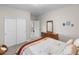 Bedroom with carpet, closet, a bed, and wooden dresser and mirror at 2060 Peralta Loop, Castle Rock, CO 80104