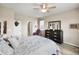 Comfortable bedroom with ceiling fan, dresser, and a view of the walk-in closet at 2060 Peralta Loop, Castle Rock, CO 80104