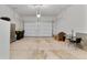 Spacious garage with concrete floor, overhead lighting and front facing garage door at 2060 Peralta Loop, Castle Rock, CO 80104