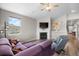 Cozy living room features a fireplace with mantel, laminate floors, and a large window with backyard views at 2060 Peralta Loop, Castle Rock, CO 80104