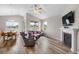 Open-concept living space with laminate flooring, fireplace, and bright natural light from the dining area at 2060 Peralta Loop, Castle Rock, CO 80104