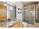 Bright bathroom with a granite countertop, wooden shelves, and a glass-enclosed shower at 2900 W 44Th Ave # 301, Denver, CO 80211