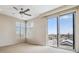 Bedroom featuring a ceiling fan, large windows, and access to a balcony at 2900 W 44Th Ave # 301, Denver, CO 80211