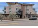 Modern apartment building exterior with a flowering tree and street parking at 2900 W 44Th Ave # 301, Denver, CO 80211