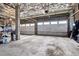 Spacious garage with exposed ceiling, two garage doors and storage at 2900 W 44Th Ave # 301, Denver, CO 80211