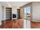 Bright living room featuring a fireplace, built-in shelving and sliding glass door to a balcony at 2900 W 44Th Ave # 301, Denver, CO 80211