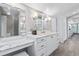 Spacious bathroom boasts white cabinets, marble countertops, and modern fixtures at 3500 S Franklin St, Englewood, CO 80113