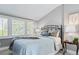 Cozy bedroom featuring a wrought iron bed frame, plantation shutters and neutral decor at 3500 S Franklin St, Englewood, CO 80113
