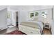 Bright bedroom with a comfortable bed, built-in drawers, and wood floors at 3500 S Franklin St, Englewood, CO 80113