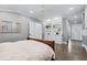 Bedroom showcasing hardwood floors, built-in shelving, and bright neutral paint at 3500 S Franklin St, Englewood, CO 80113