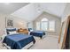 Bright bedroom with matching twin beds, vaulted ceiling, and large arched window at 3500 S Franklin St, Englewood, CO 80113