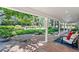 Relaxing covered patio with flagstone flooring, elegant seating, and views of the lush, landscaped backyard at 3500 S Franklin St, Englewood, CO 80113