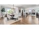 Elegant dining area with hardwood floors, chandelier, and seamless flow into the living room at 3500 S Franklin St, Englewood, CO 80113