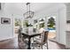 Dining room with modern lighting and direct access to the pool and outdoor space via French doors at 3500 S Franklin St, Englewood, CO 80113
