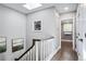 Well-lit hallway features hardwood floors, white banister, and a decorative skylight at 3500 S Franklin St, Englewood, CO 80113