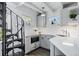 Modern kitchen with gray cabinets and spiral staircase at 3500 S Franklin St, Englewood, CO 80113