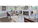 Cozy living room with fireplace, hardwood floors, built-in shelves, and abundant natural light at 3500 S Franklin St, Englewood, CO 80113