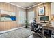 Bright home office with wood paneled walls, natural light, modern desk, and hardwood floors at 3500 S Franklin St, Englewood, CO 80113