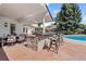 A well-equipped outdoor kitchen with a built-in grill and bar seating, perfect for poolside entertaining and summer gatherings at 3500 S Franklin St, Englewood, CO 80113