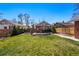 Lush backyard with green grass, wooden fence, and a patio for outdoor relaxation at 3345 W Clyde Pl, Denver, CO 80211