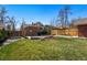 Spacious backyard showcasing the lawn, brick home exterior, and privacy fencing at 3345 W Clyde Pl, Denver, CO 80211