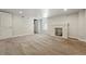Spacious basement area featuring neutral carpet and a classic white brick fireplace at 3345 W Clyde Pl, Denver, CO 80211