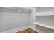 Walk-in closet with wood floors, built-in shelving, and ample storage for a tidy and organized space at 3345 W Clyde Pl, Denver, CO 80211