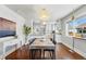 Open dining area with a modern chandelier and a view to the kitchen at 3345 W Clyde Pl, Denver, CO 80211