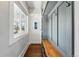 Inviting entryway with custom built-ins, coat hooks, and a wooden bench, creating a functional and stylish space at 3345 W Clyde Pl, Denver, CO 80211