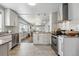 Bright kitchen features granite countertops, stainless steel appliances, and an open layout to the living room at 3345 W Clyde Pl, Denver, CO 80211