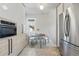 Eat in kitchen area with table, chairs, oven, and stainless steel refrigerator at 3345 W Clyde Pl, Denver, CO 80211