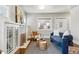 Cozy living room with a fireplace, hardwood floors, and natural light at 3345 W Clyde Pl, Denver, CO 80211