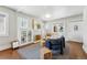 Bright living room with hardwood floors, a fireplace, and a cozy seating area at 3345 W Clyde Pl, Denver, CO 80211