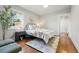 Bright main bedroom featuring a soft color palette, natural light, and hardwood floors at 3345 W Clyde Pl, Denver, CO 80211