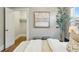 Bedroom view showcasing a closet, modern art, and natural light enhancing the bright and airy space at 3345 W Clyde Pl, Denver, CO 80211