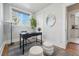 Bright office space with stylish black desk, modern decor, and ample natural light from the large window at 3345 W Clyde Pl, Denver, CO 80211